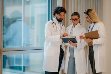 Medical team using digital tablet for patient consultation in hospital