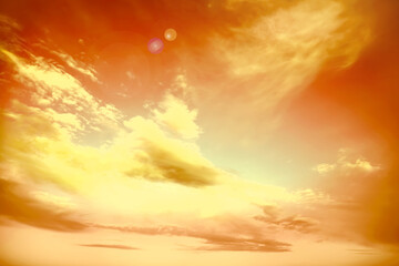 Orange sky with clouds during hot summer weather