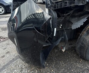 Black car with a smashed front end