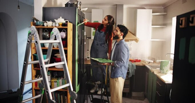Couple, planning and smile with painting for kitchen renovations, upgrade and maintenance. New home, people and happy for DIY, makeover and decoration decision with creative homeowner and art tools