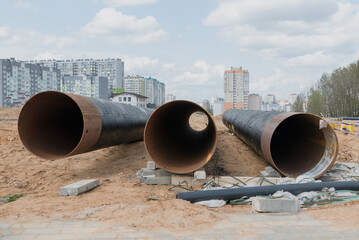 urban sewage infrastructure in the background, multi-storey buildings are blurred. Water pipes on...