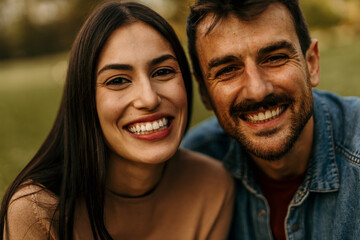 Happy couple smiling together outdoors in nature
