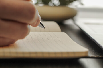 Close-Up of Pen Tip Hovering Above Blank Notepad Page