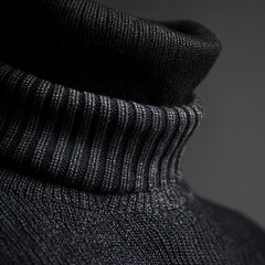 Close-up shot of a dark gray turtleneck sweater, highlighting the fabric texture and collar design.