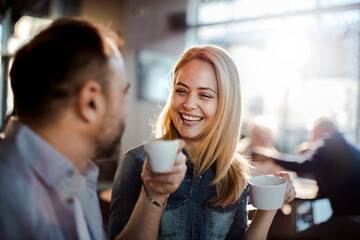 Smiling couple enjoying coffee and conversation at cafe