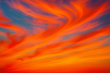 Vibrant orange and red clouds in dramatic sunset sky