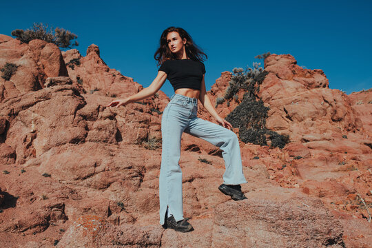 Young beautiful woman posing in the mountains on summer day