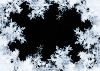 Frame of snowflakes creating a border on a black background, perfect for winter and christmas themes