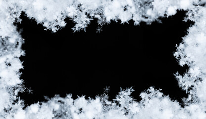 Frame of snowflakes creating a border on a black background, perfect for winter and christmas themes