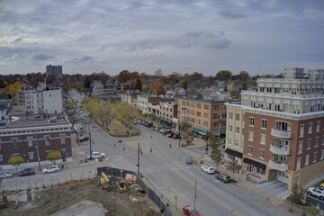 Aerial view of a quiet street lined with buildings under a cloudy sky, contrasting with a construction site in the foreground, Cincinnati, Ohio, United States.
