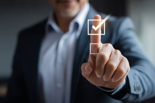 Businessman in suit selecting a virtual checkbox with a glowing checkmark for successful decision or approval concept
