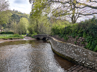 Dunster UK, March 15, 2025. The Gallox Bridge in Dunster, Somerset, England dates from the 15th century. with two arches over the River Avill. It was originally known as Gallows Bridge