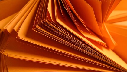 Close-up of stacked, orange paper