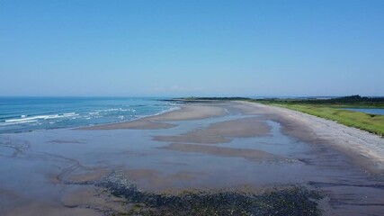 Bartlett's public beach in Digby County, Nova Scotia, Canada.  A drone fly over of the beach with wisps of mist rising. - Powered by Adobe