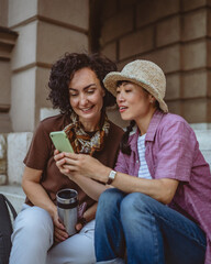female tourist use mobile phone for directions while sit on staircase