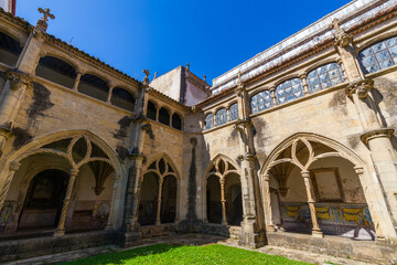 Fototapeta premium The final image) presents a wide-angle view of a historic monastery courtyard, showcasing its multi-tiered arched architecture with a mix of stone and tiled details