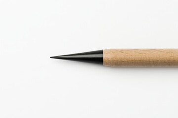 Sleek wooden pencil highlighted in full view, emphasizing its sharp graphite tip set against a clean, minimalistic surface