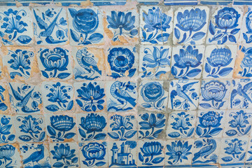 a detailed close-up of a wall covered in traditional Portuguese blue and white azulejo tiles
