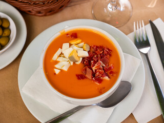 Salmorejo - traditional thick and creamy cold soup from tomatoes served with pieces of jamon....