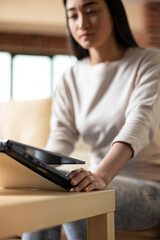 Focused woman entrepreneur touching laptop lid, getting ready to check emails and research upcoming...
