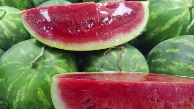 Slices of Crimson Watermelon Cut on Market Counter Footage.