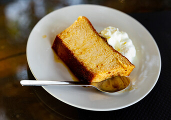 Indulge in creamy, delectable pudding served elegantly on pristine porcelain plate.