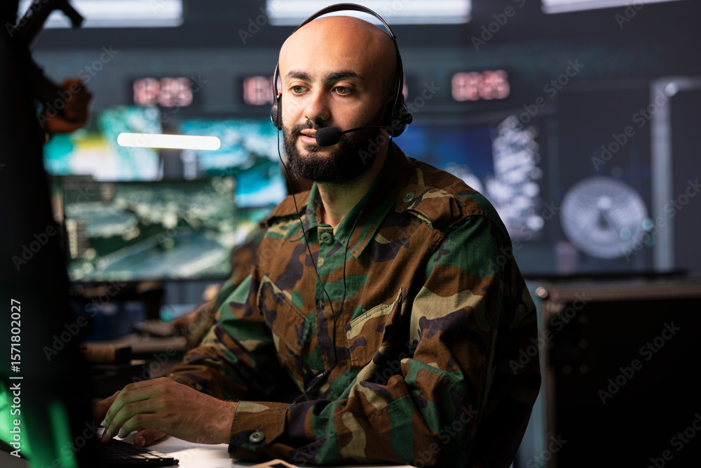 Poster agent in command room uses military tech to identify threats from enemies. army operator in base of 