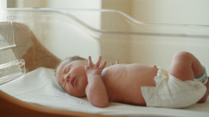 newborn baby in hospital bed