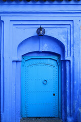 Traditional powder blue painted medieval house facade and door in the historical Medina of...