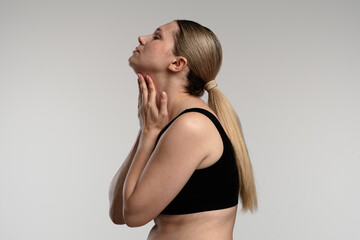 Woman with Neck Pain Holding Throat in Side Profile View