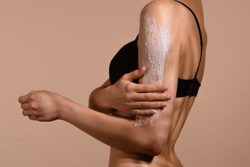 Woman Applying Scrab to Arm for Skincare Routine