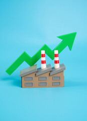 Factory building and green arrow pointing up. Good economic performance of the enterprise. Profit...
