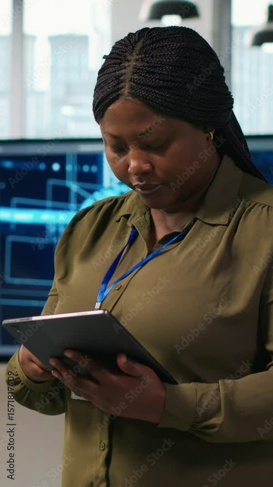 Poster vertical video smiling female engineer next to office coworkers developing software applications, in