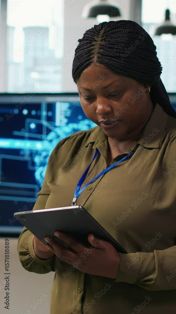 Poster vertical video happy female engineer in office automating repetitive tasks using ai scripts. jolly a