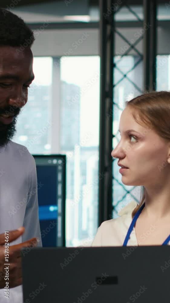 Poster vertical video female engineer and coworker coding ai algorithms to debug software issues and improv