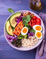 Low-carb meal spread with grilled salmon, eggs, avocado, nuts, leafy greens, and olive oil on a rustic table. Bright, natural light highlights fresh, healthy ingredients.