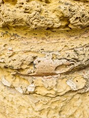 Close up of Weathered Yellow Rock Surface Showing Erosion and Texture