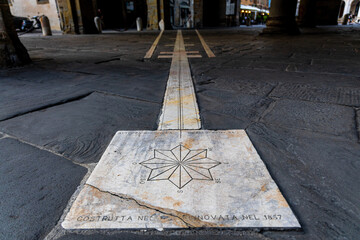 Streets of Bergamo’s Città Alta in Italy with terracotta rooftops, historic churches, and mountain backdrop on a clear day