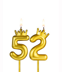 Golden number 52 birthday candle on white background