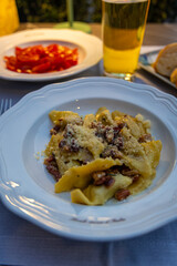 Food in Bergamo’s Città Alta in Italy with terracotta rooftops, historic churches, and mountain backdrop on a clear day
