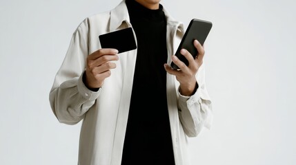 Business Mobile Payments Cardless Person Holding Phone and Card with Neutral Background for Online Shopping