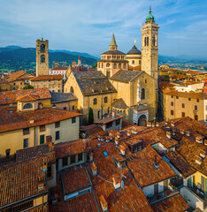 Aerial view of Bergamo’s Città Alta in Italy with terracotta rooftops, historic churches, and...