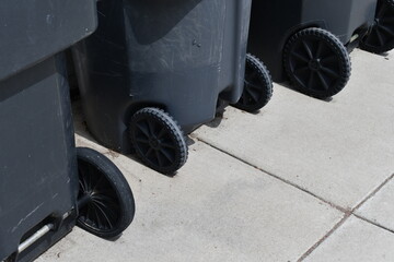 Residential garbage bins. Closeup of plastic wheels.