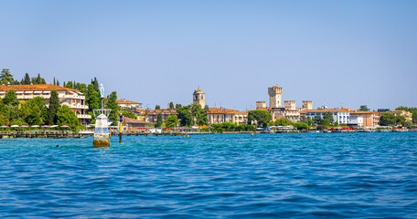 Aerial view of historic Scaliger Castle in Sirmione, Italy, surrounded by mountains