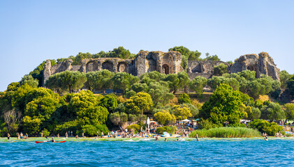 Aerial view of historic Scaliger Castle in Sirmione, Italy, surrounded by mountains
