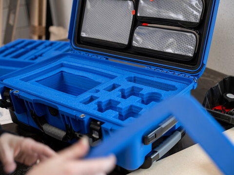 Blue protective equipment case with custom foam inserts and compartments for gear storage and transport