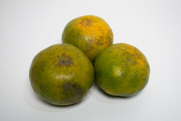 Orange fruit with a combination of green and orange colors, showing freshness and natural texture.