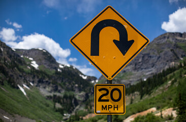 Hairpin turn sign on the Million Dollar Highway in the San Juan Mountains, Colorado in summer 