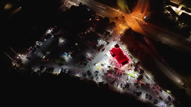 Static top-down night view of fast food drive-thru and parking lot in Los Angeles