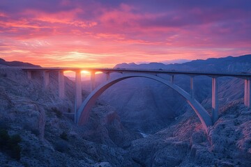 Majestic sunset over mountain bridge with vibrant sky and rugged terrain